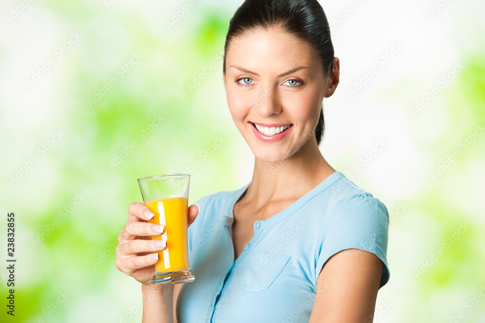 Young beautiful woman with glass of orange juice, outdoor Young beautiful woman with glass of orange juice, outdoor
