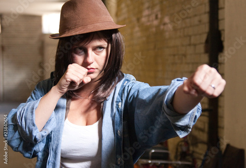 Attractive girl throwing a punch photo
