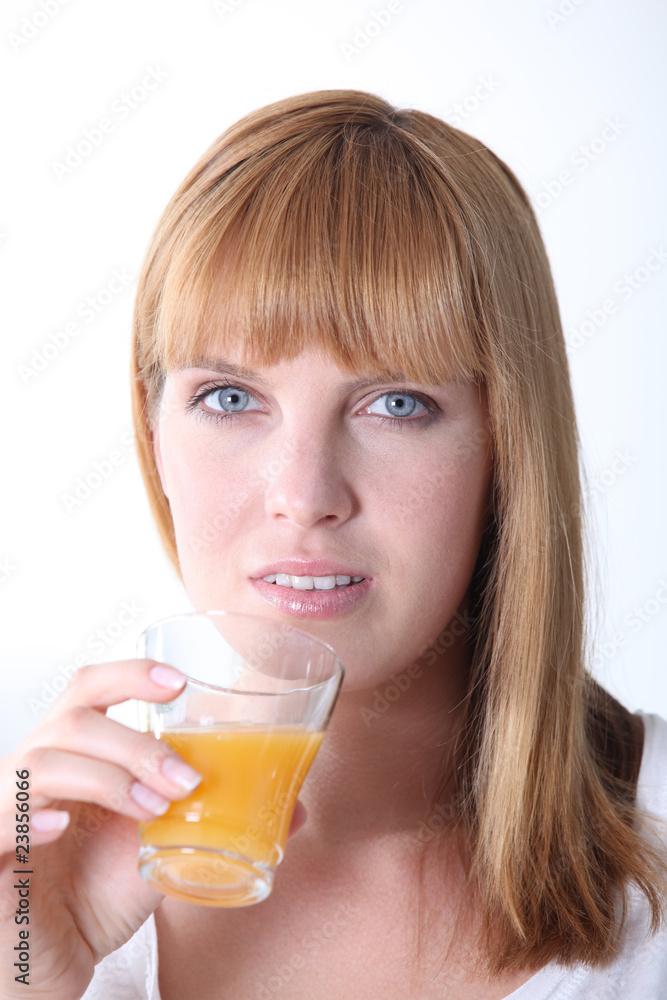 Closeup of a woman drinking orange juice on white background Closeup of a woman drinking orange juice on white background