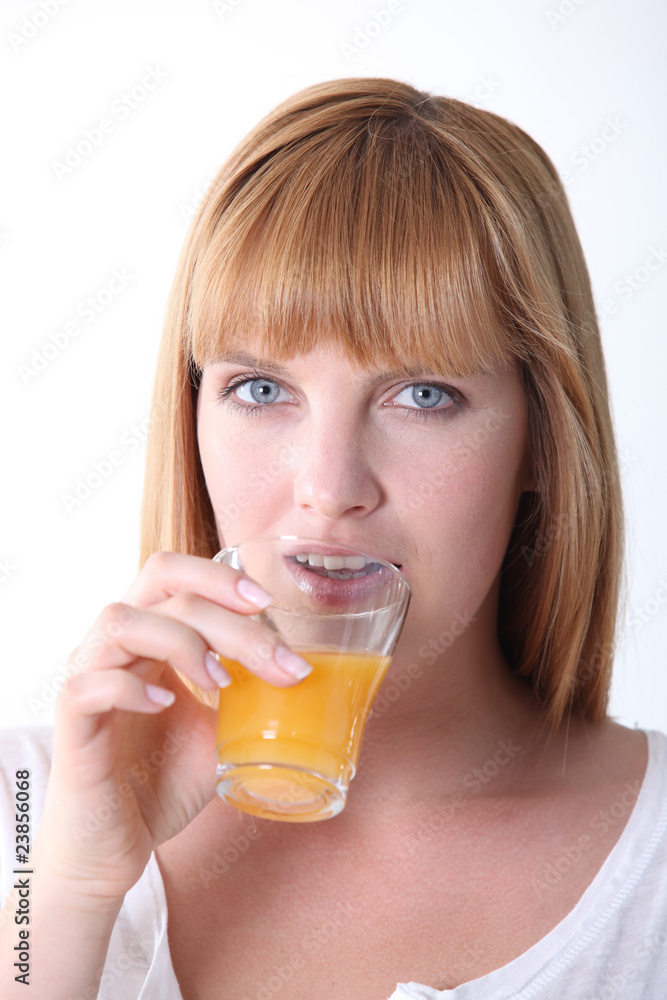 Clsoeup of a woman drinking orange juice on white background Clsoeup of a woman drinking orange juice on white background