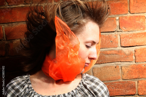 womanish portrait on a background a brick wall