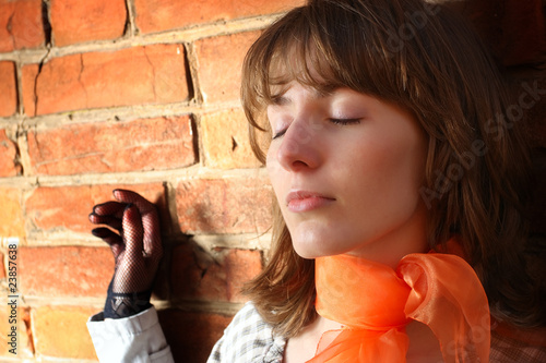 womanish portrait on a background a brick wall