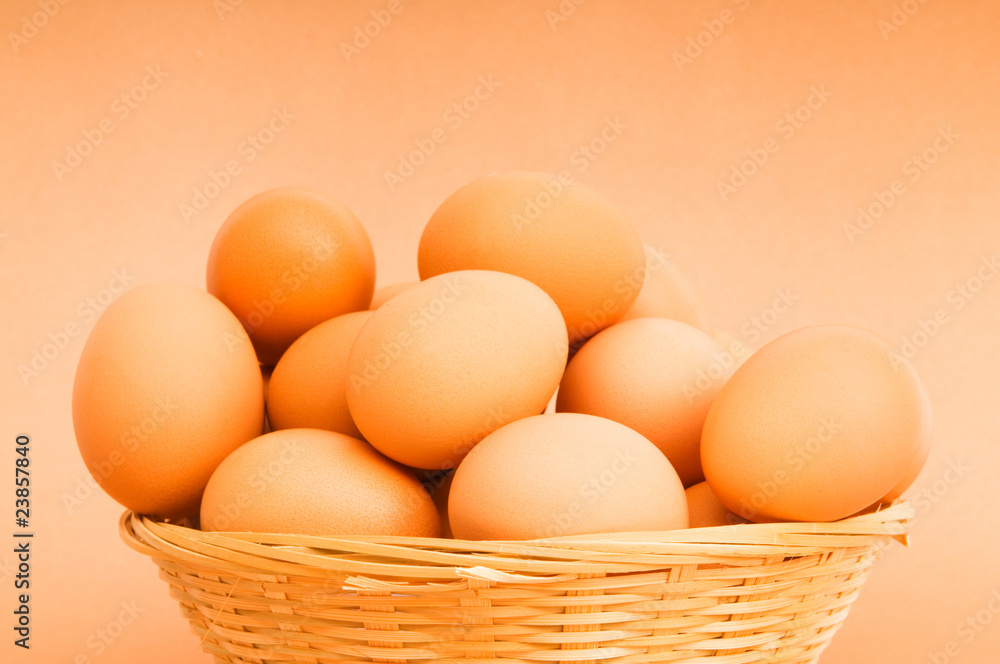 Basket of eggs on the colourful background Basket of eggs on the colourful background