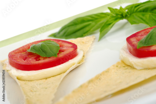 Mozzarella, tomato, basil, on crocantini (Selective Focus)