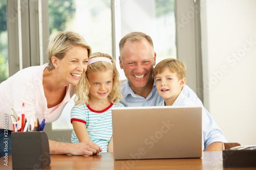 Family Using Laptop At Home © Monkey Business