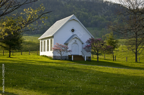 White wooden country church on hilltop in Virginia mountains.