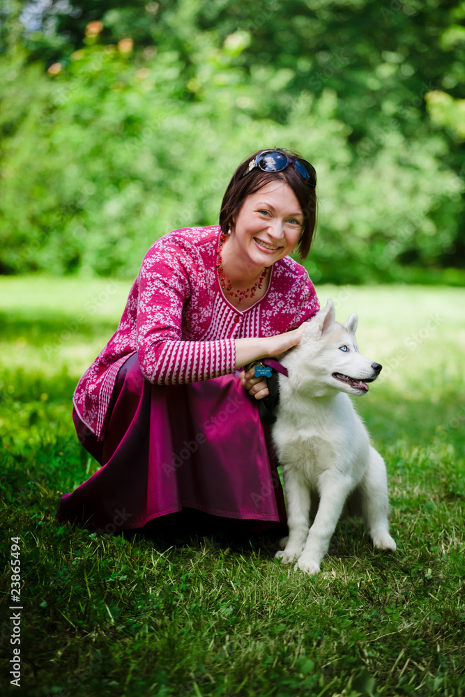 beautiful girl with puppy of husky in park beautiful girl with puppy of husky in park