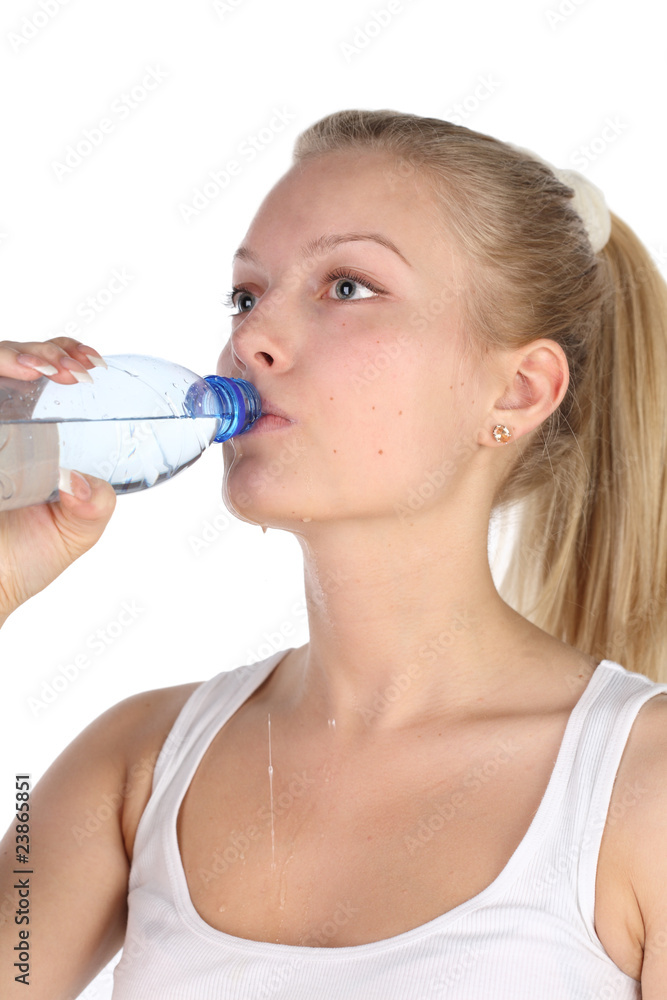 beautiful girl drinks mineral water from plastic bottle. beautiful girl drinks mineral water from plastic bottle.