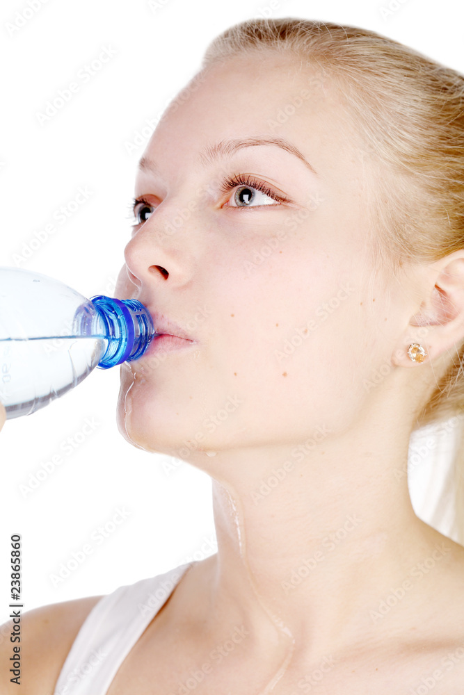 beautiful girl drinks mineral water from plastic bottle. beautiful girl drinks mineral water from plastic bottle.