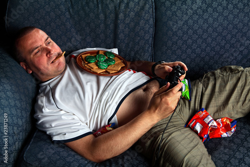 England football supporter slob on sofa playing games