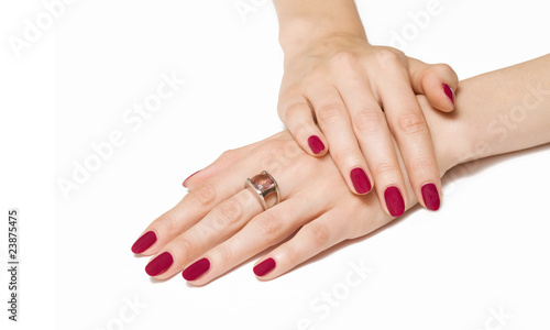 Woman hands with pink manicure and zirconium ring