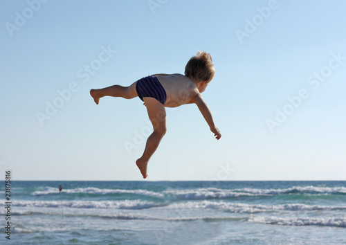 flying child on sky and sea background