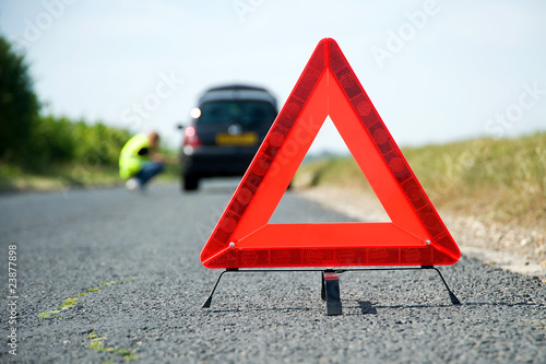 Red warning triangle with a broken down car
