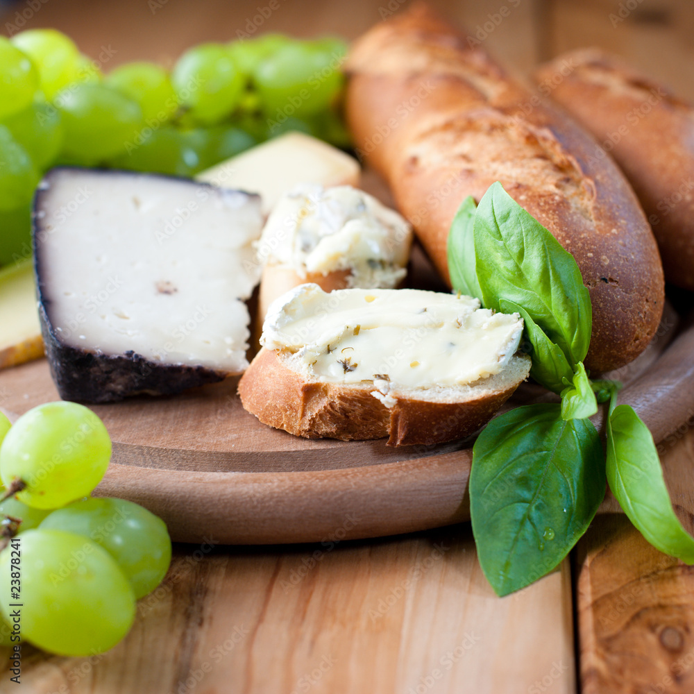 Cheeses with baguette,grapes and fresh herbs Cheeses with baguette,grapes and fresh herbs