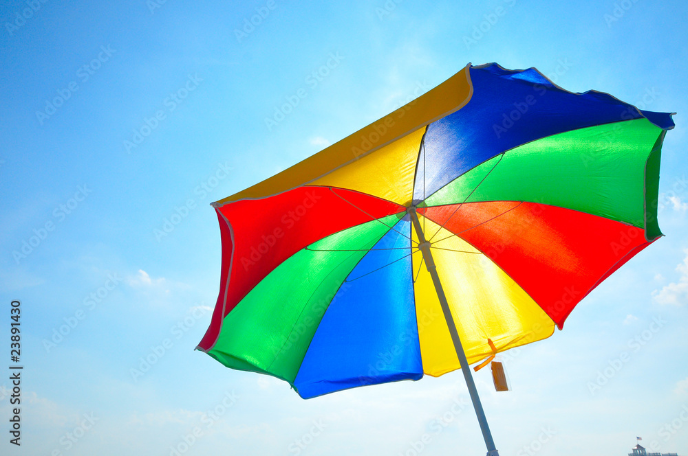 Obraz premium colorful beach umbrella with blue sky