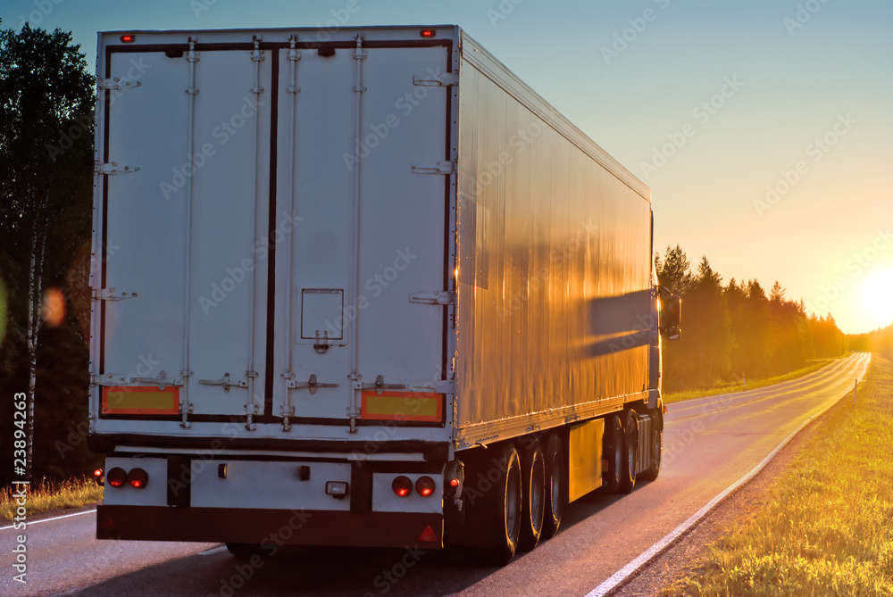 Truck on wood road in the evening Truck on wood road in the evening