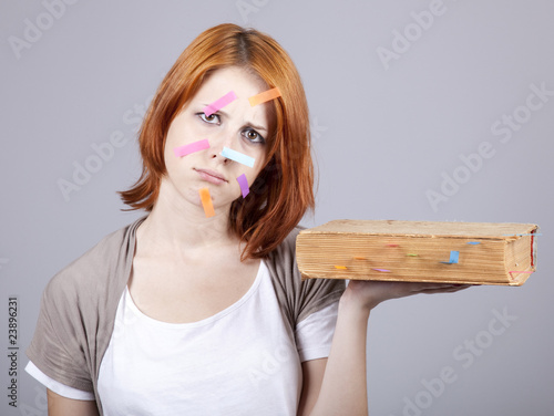 Canvas Print Red-haired businesswoman with book and notes on face.