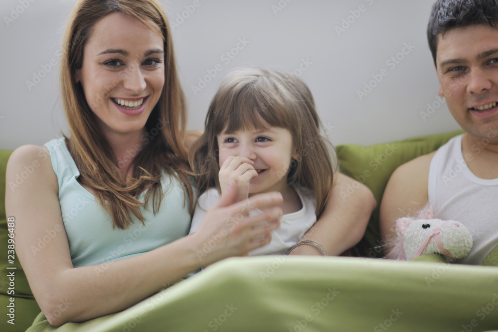 happy family relaxing in bed