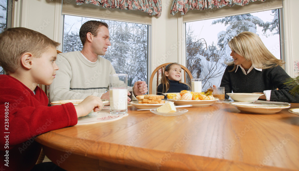 Family Smiles At Breakfast Table Family Smiles At Breakfast Table