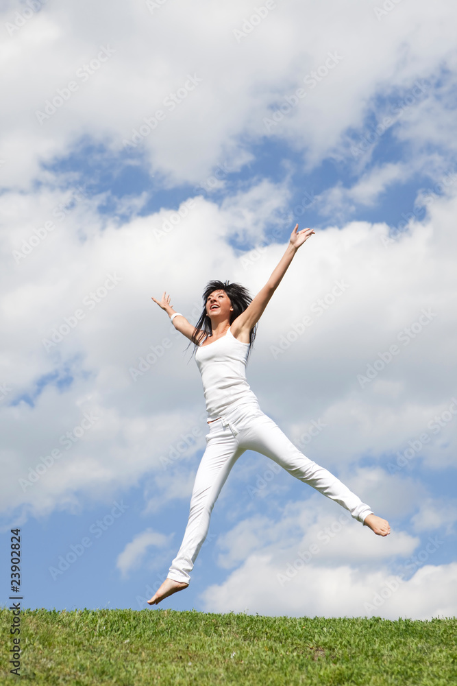 pretty young woman jumping on green grass pretty young woman jumping on green grass