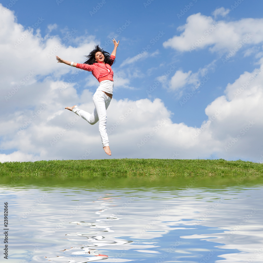 pretty young woman jumping on green grass pretty young woman jumping on green grass