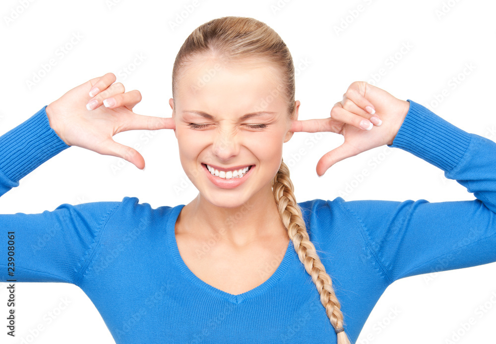 smiling woman with fingers in ears smiling woman with fingers in ears