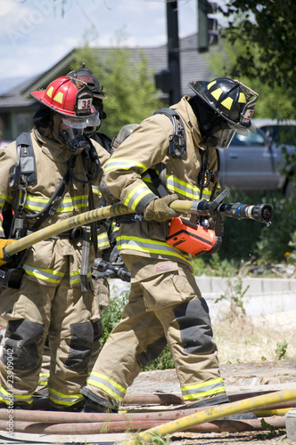 fire fighters with fire hose