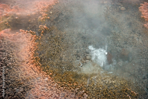 Closeup of a geyser with orange sediment