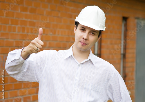 Happy builder with  thumbs up photo