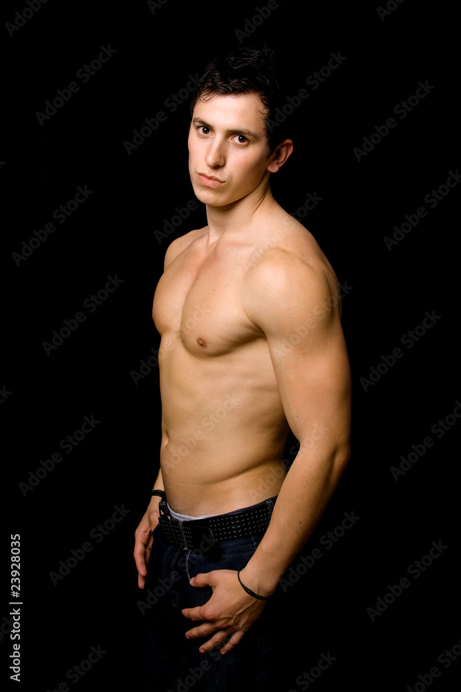 Young man with atletic body on black background Young man with atletic body on black background