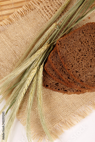 Wheat, bread on a bast mat