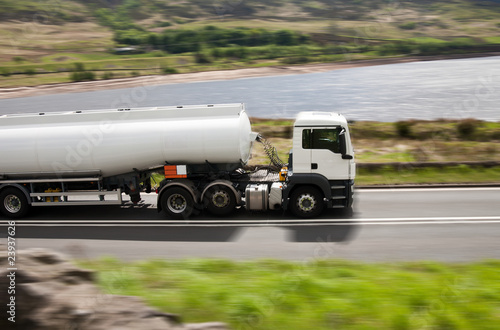 Big fuel gas tanker truck on blurred road