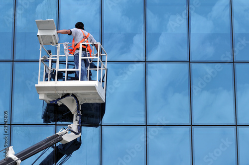 Window washer on a highrise office building in downtown