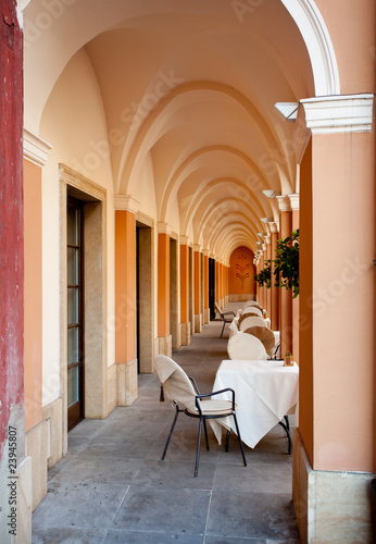 Arched restaurant with cloth covered tables #23945807