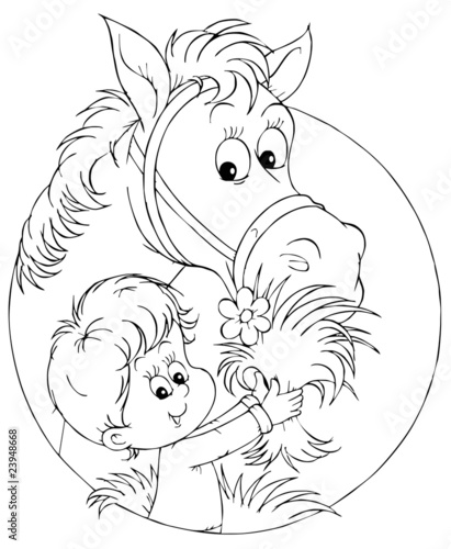 small boy feeds a horse
