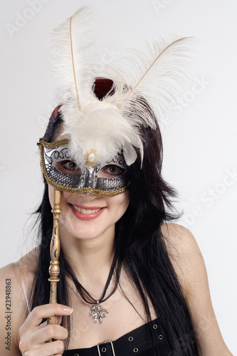 Young woman with mask smiling and long black hair photo