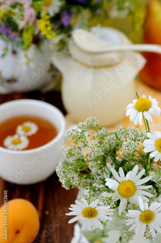 Field flowers and chamomile tea   background 