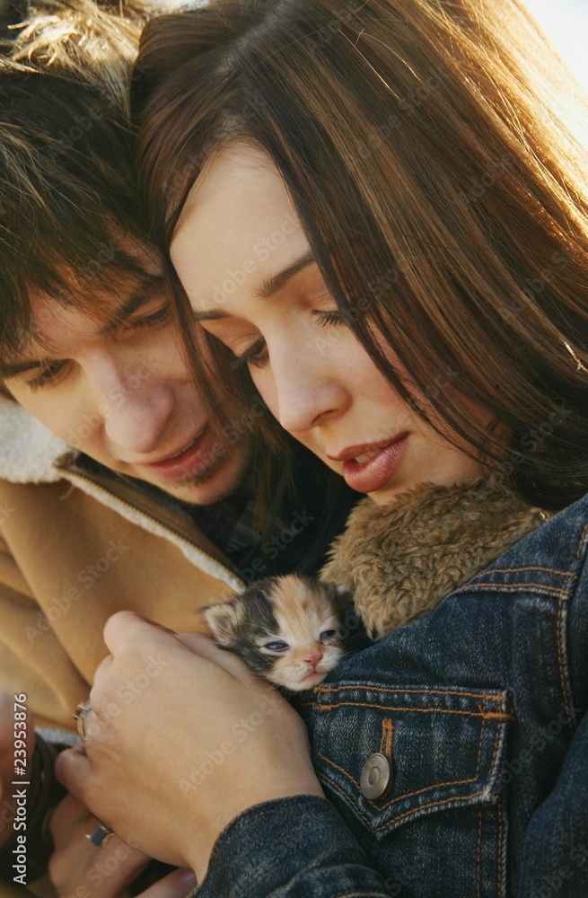 Couple Cuddle A Kitten Couple Cuddle A Kitten