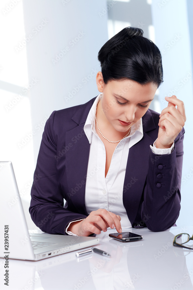 business woman fixing a date on a smartphone business woman fixing a date on a smartphone