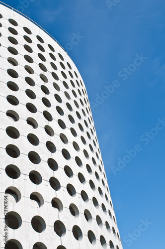 Facade of new extravagant spotted building. Parking garage.