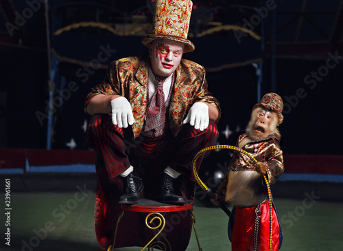 Circus clown with a monkey.