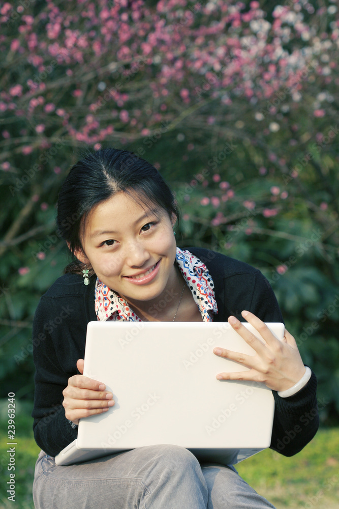 A beautiful Asian business woman with her laptop A beautiful Asian business woman with her laptop