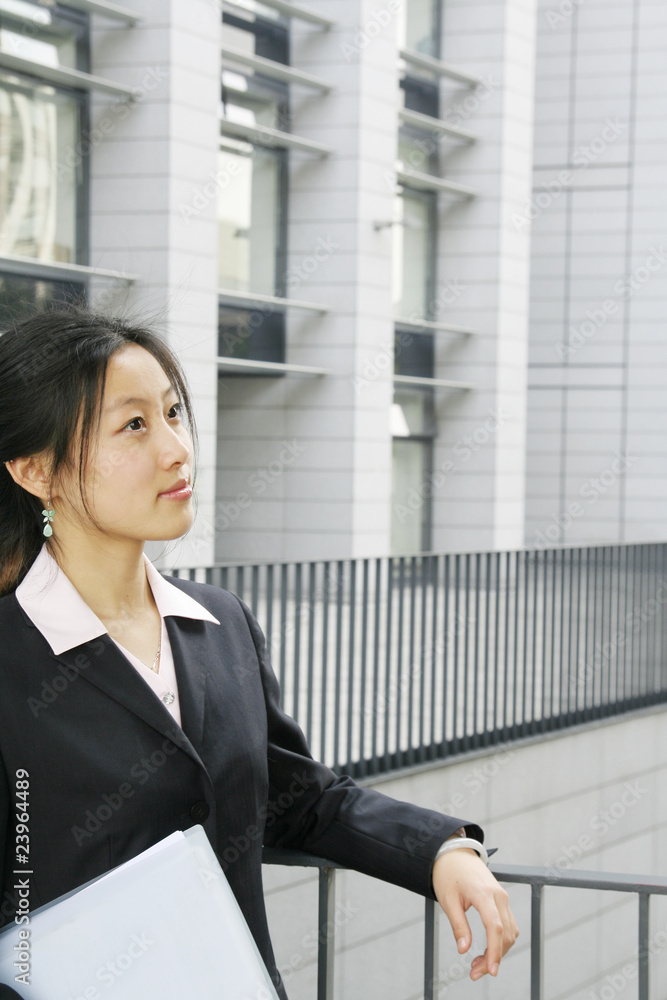 A beautiful Asian businesswoman holding the  documents
