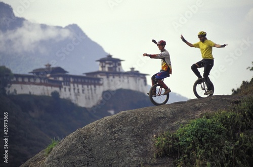 Unicyclists Riding Down Hill