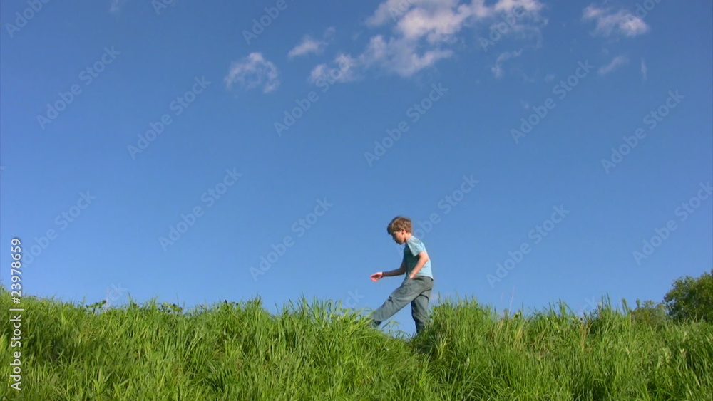 boy walking on grass in field under sky boy walking on grass in field under sky