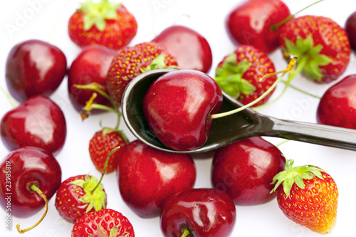 Fototapeta Naklejka Na Ścianę i Meble -  cherry and strawberry in a spoon isolated on white