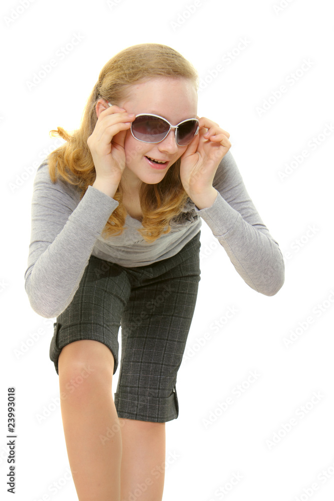 Girl in sunglasses slyly smiles Girl in sunglasses slyly smiles