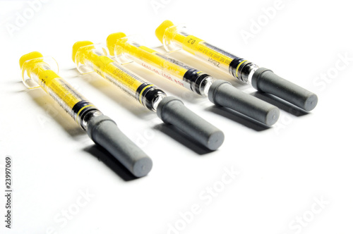 Glass syringe isolated on white