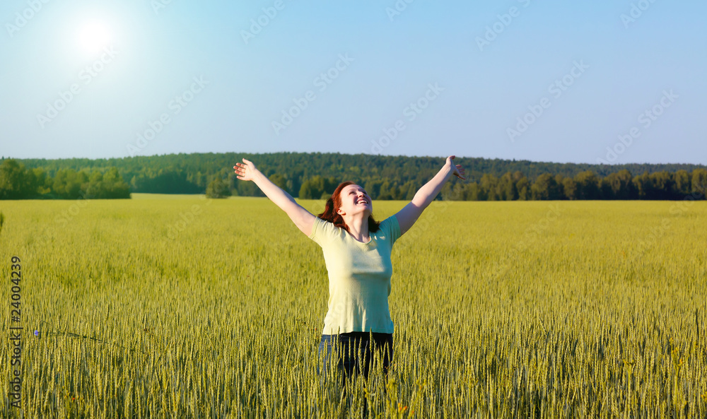 woman with open arms in green field woman with open arms in green field