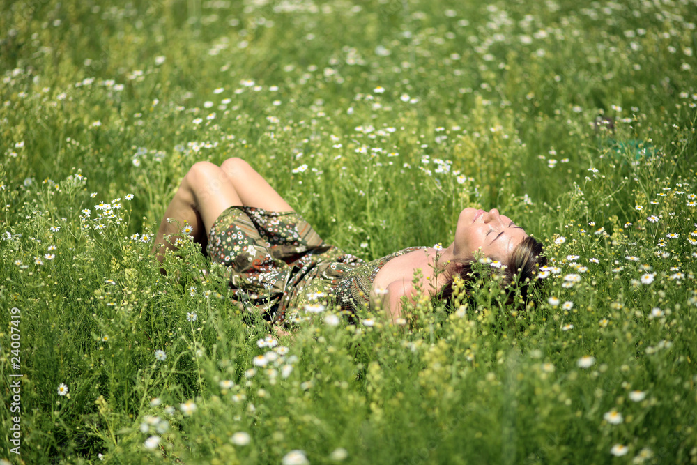 Girl resting on meadow